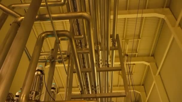 Modern large filter system inside of plant with yellow lighting — Stock Footage Modern Large Filter System Plant Yellow Lighting Royalty Free Stock Video