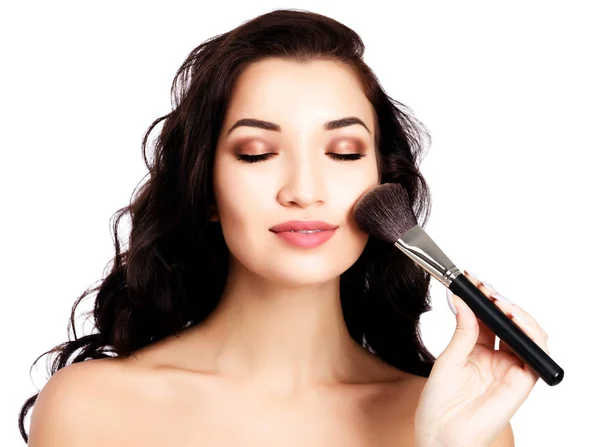 Pretty girl with a makeup brush — Stock Photo, Image