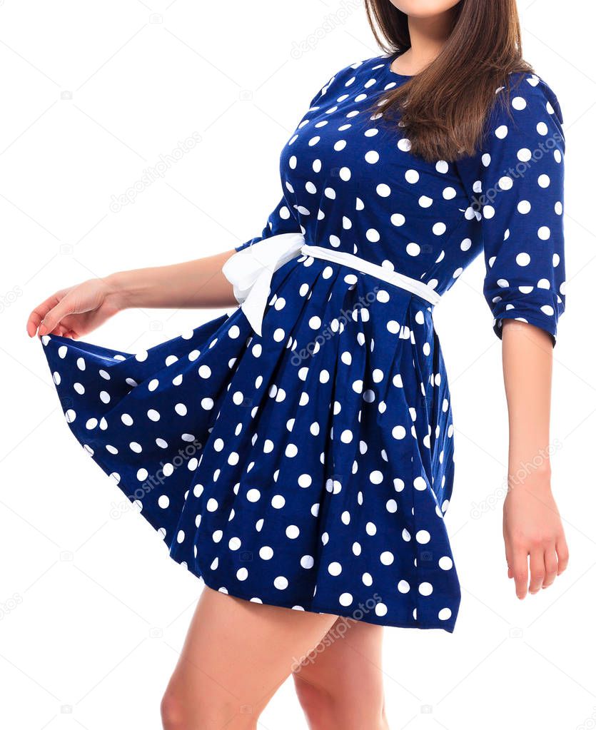 Woman in a dress with polka dot print, isolated on white backgro