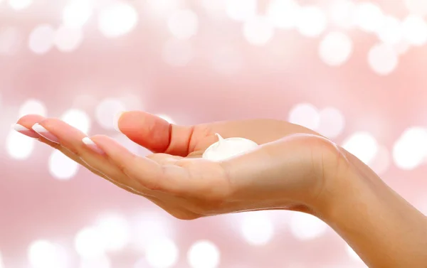 Woman hand with a cream on an abstract background — Stock Photo, Image