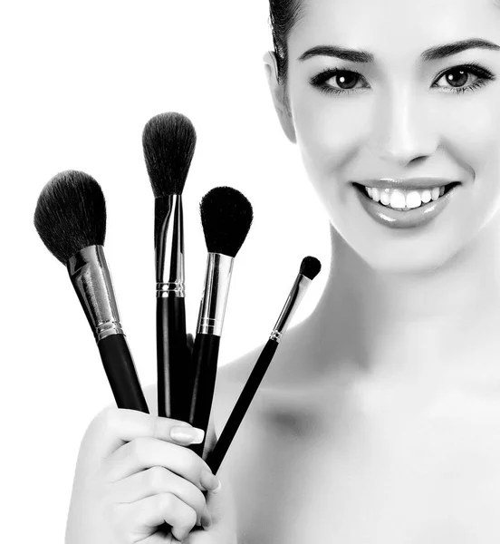 Female with cosmetic brushes, white background, copyspace — Stock Photo, Image