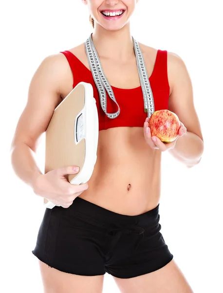 Smiling fit woman with scale and apple, isolated on white backgr — Stock Photo, Image