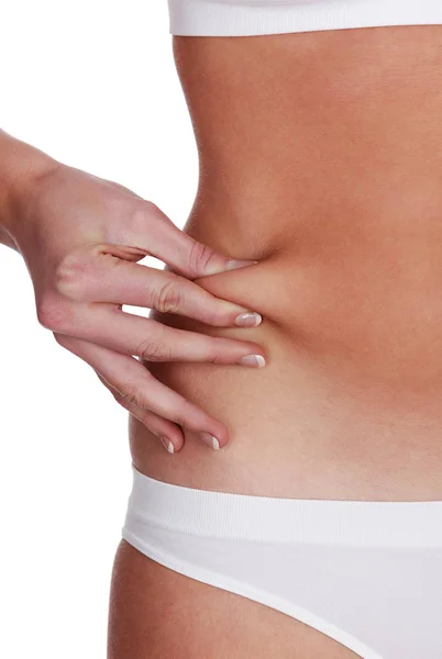 Mulher belisca gordura na barriga — Fotografia de Stock