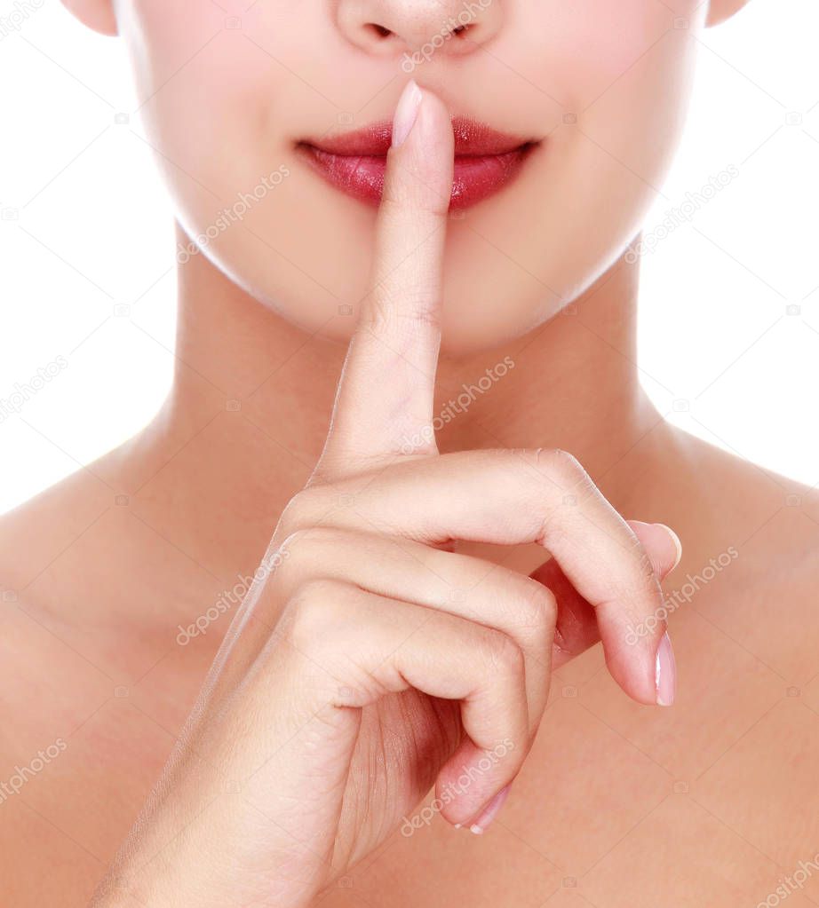 Secret. beautiful girl with her finger near the lips