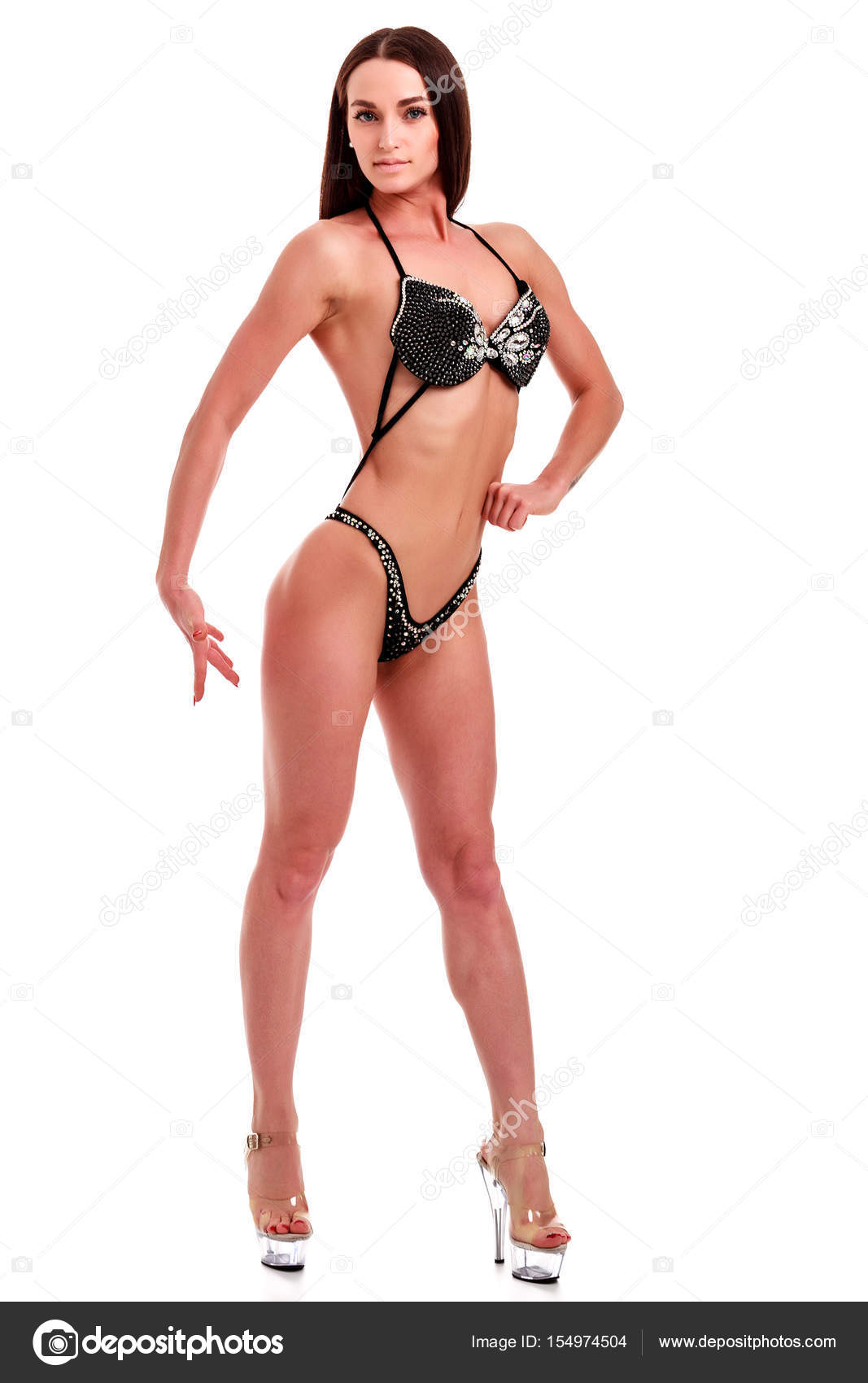 Young beautiful athletic girl with sexy body in bikini. Isolated