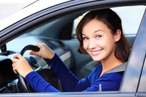 Mujer hermosa conductor sonriendo a usted desde su coche —  Fotos de Stock