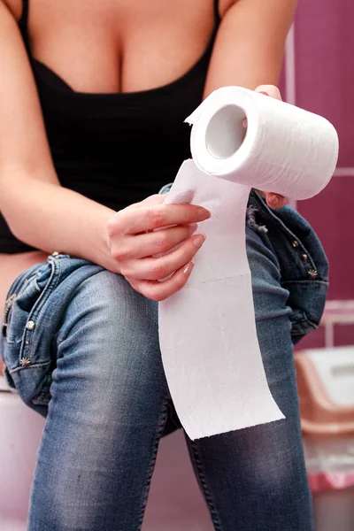 Closeup picture of a woman sitting in a toilet room — Stock Photo, Image