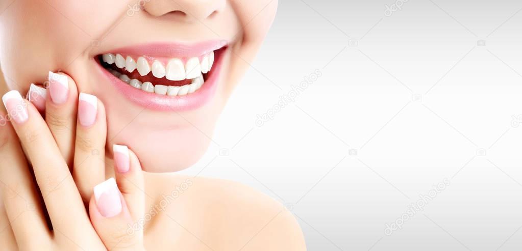 Closeup shot of happily laughing pretty woman against a grey background with copyspace