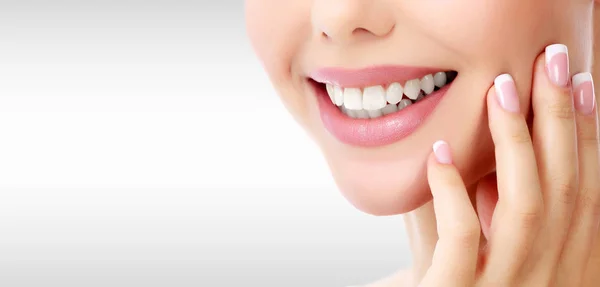 Closeup shot of woman's toothy smile against a grey background with copyspace — Stock Photo, Image