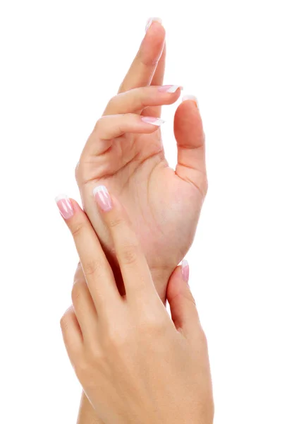 Primer plano de las manos de la mujer con manicura francesa y piel limpia y suave sobre un fondo blanco, aislado —  Fotos de Stock
