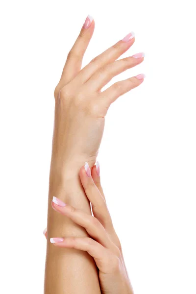 Closeup shot of woman's hands with french manicure and clean and soft skin over a white background, isolated — Stock Photo, Image