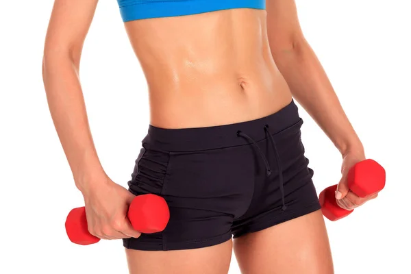 Beautiful body of a young fit slim woman lifting dumbbells isolated on white background — Stock Photo, Image