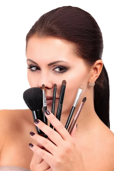 Closeup portrait of beautiful woman with makeup brushes, isolated on white background — Stock Photo, Image