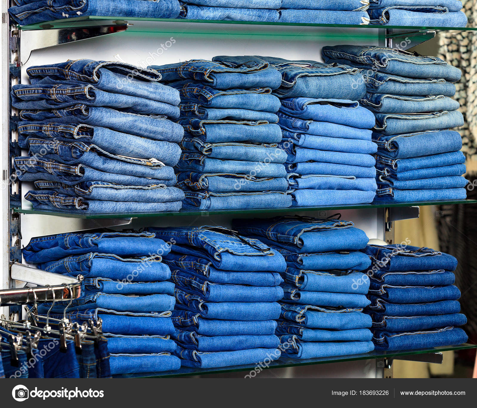 Closeup shot of stack of folded jeans in the fashion store Stock Photo by  ©Nobilior 183693226