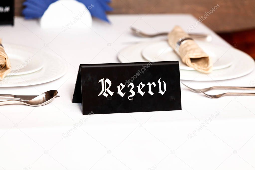 Closeup shot of restaurant reserved table sign 