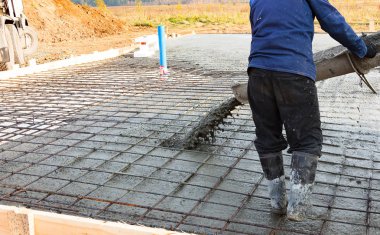 Endüstriyel inşaat alanında yerde güçlendiren metal çubukları üzerindeki beton döküm closeup çekim