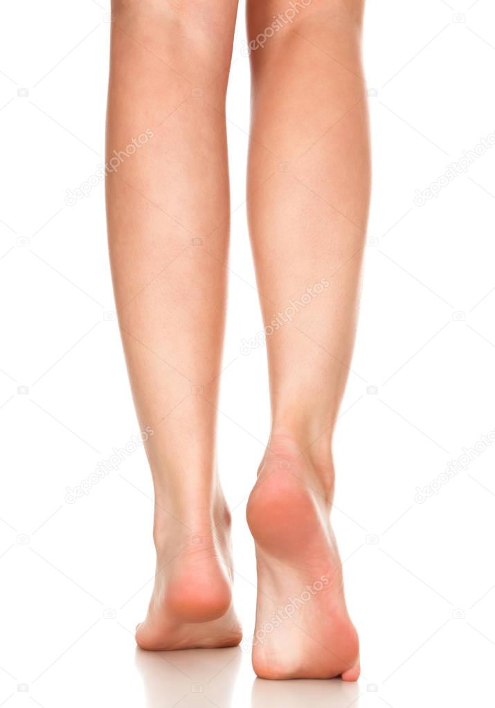Closeup shot of female bare feet, isolated on white background