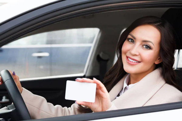 Beyaz boş kartvizit holding kadını sürücüsü gülümseyen portresi — Stok fotoğraf