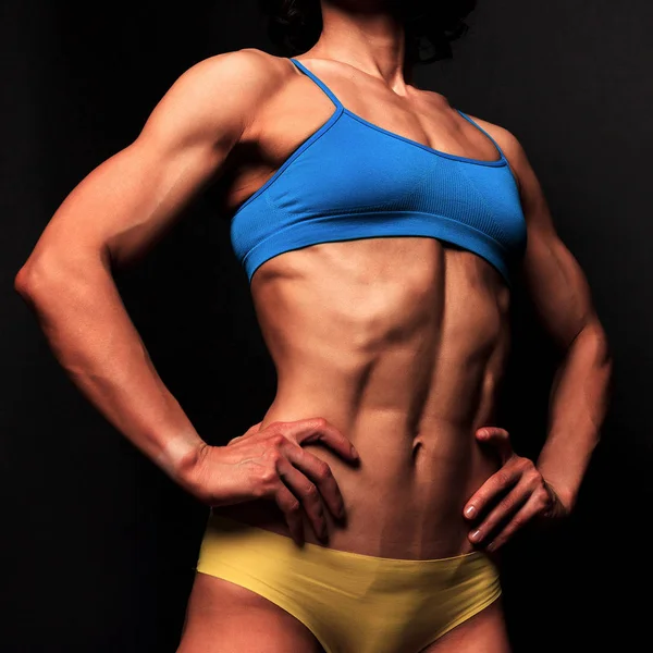 Fitness woman posing against a black background — Stock Photo, Image