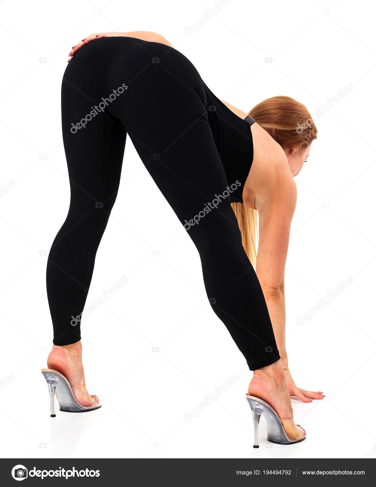 Sexy woman with long legs and big round ass posing against a