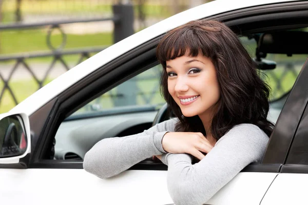 Young driver woman in white car — Stock Photo, Image