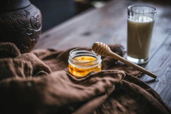 Tarro de vidrio con miel y leche — Foto de Stock