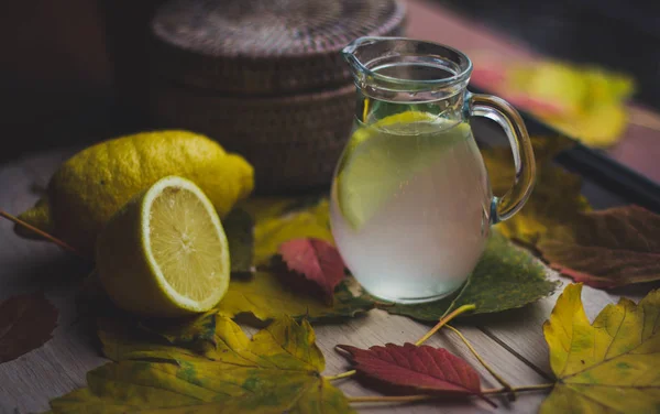 Water with lemon  in glass jug — Stock Photo, Image