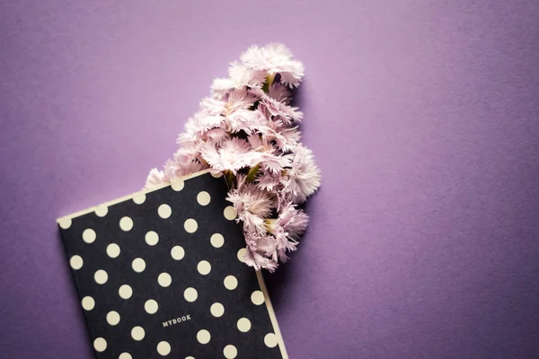 Pink flowers with notebook