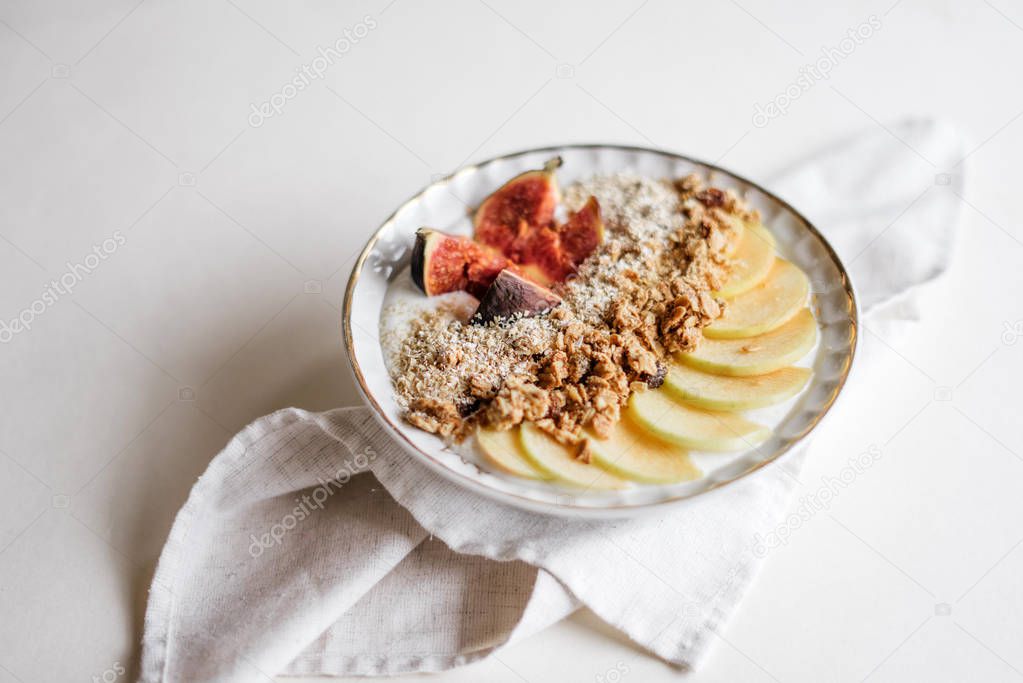 plate of granola with apple slices