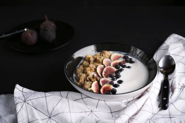 bowl with  fresh figs and berries on background, healthy breakfast concept clipart