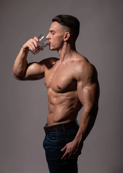 Male model drinking water from the glass