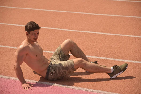 Sporty man at running track