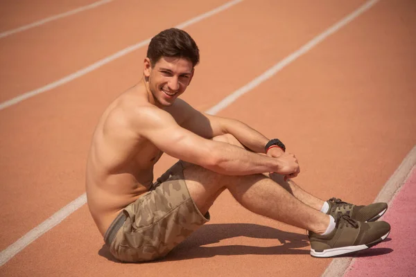 Sporty man at running track