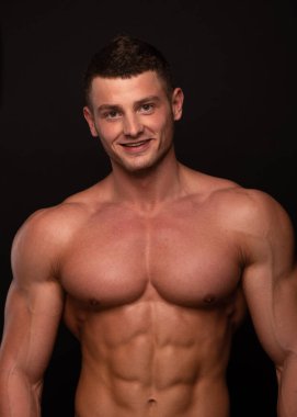 Stüdyoda poz veren kaslı adamın portresi.