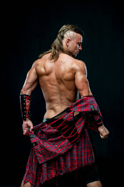 Muscled male model in kilt
