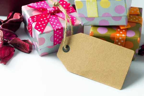Holiday presents with empty tag — Stock Photo, Image