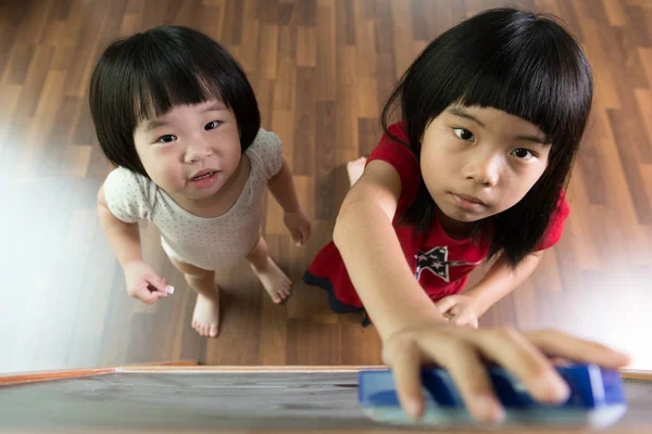 Two kids drawing on blackboard — Stock Photo, Image