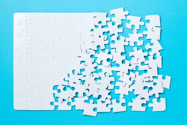 Jigsaw puzzle pieces on blue background — Stock Photo, Image
