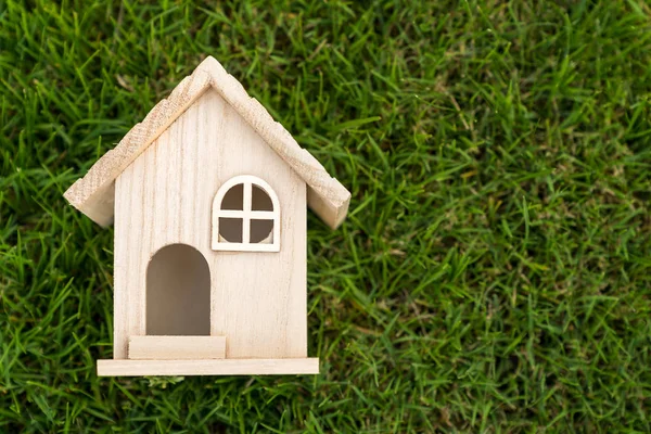 Piatto lay vista di piccola casa in legno su erba verde — Foto Stock