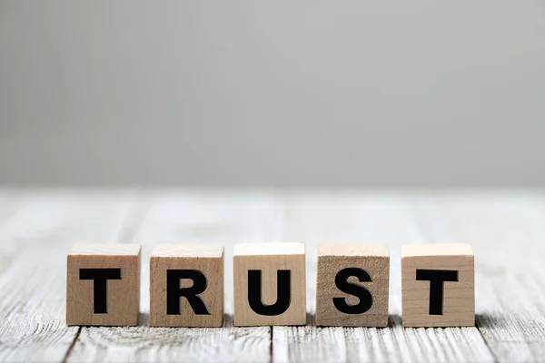 Trust word written on wood block — Stock Photo, Image