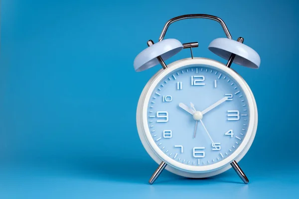 Old fashioned alarm clock on blue background — Stock Photo, Image