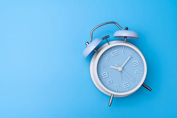 Old fashioned alarm clock on blue background — 스톡 사진