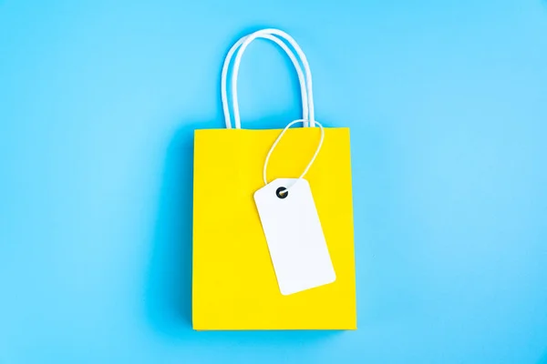 Yellow shopping or gift bag isolated on blue — 图库照片