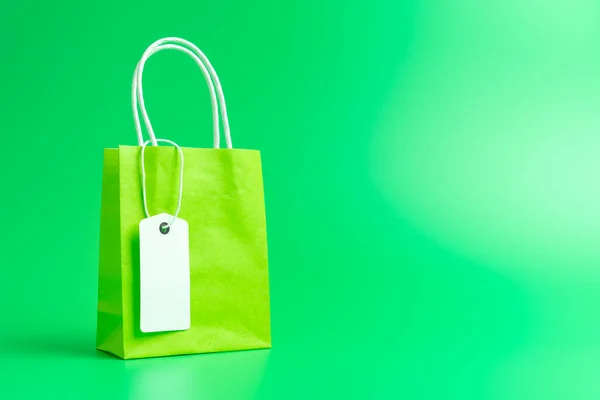 Green shopping or gift bag isolated on green background — Stock Photo, Image
