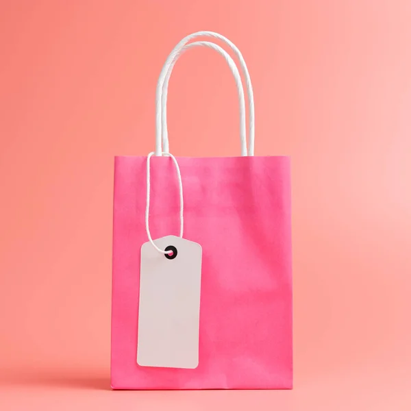 Single pink shopping or gift bag isolated on pink background — Stock Photo, Image