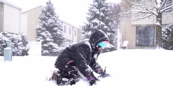 Slow motion little girl is throwing snow playing outdoors — Stock Video