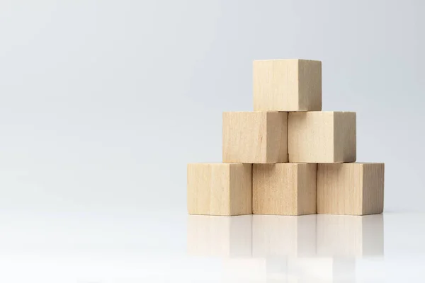 Six wooden blocks arranged in pyramid shape — Stock Photo, Image