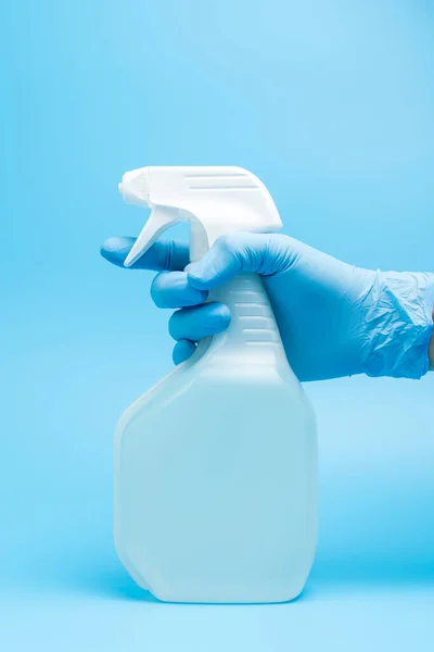 Hand in glove holds disinfectant spray — Stock Photo, Image