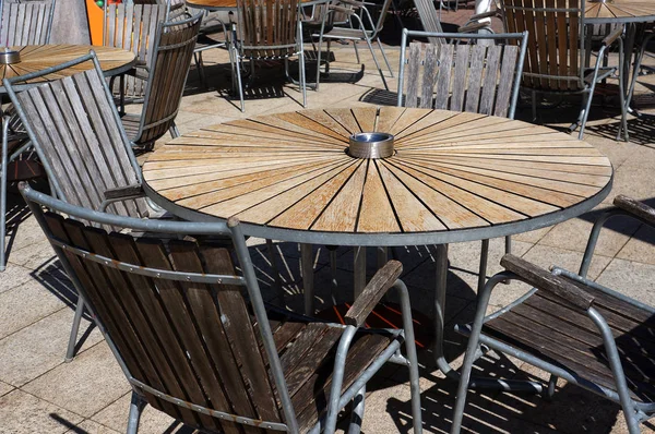 Wooden table and chairs in beach cafe.