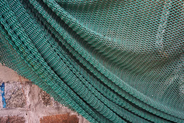 Fishing net hanging on a wall. — Stock Photo, Image